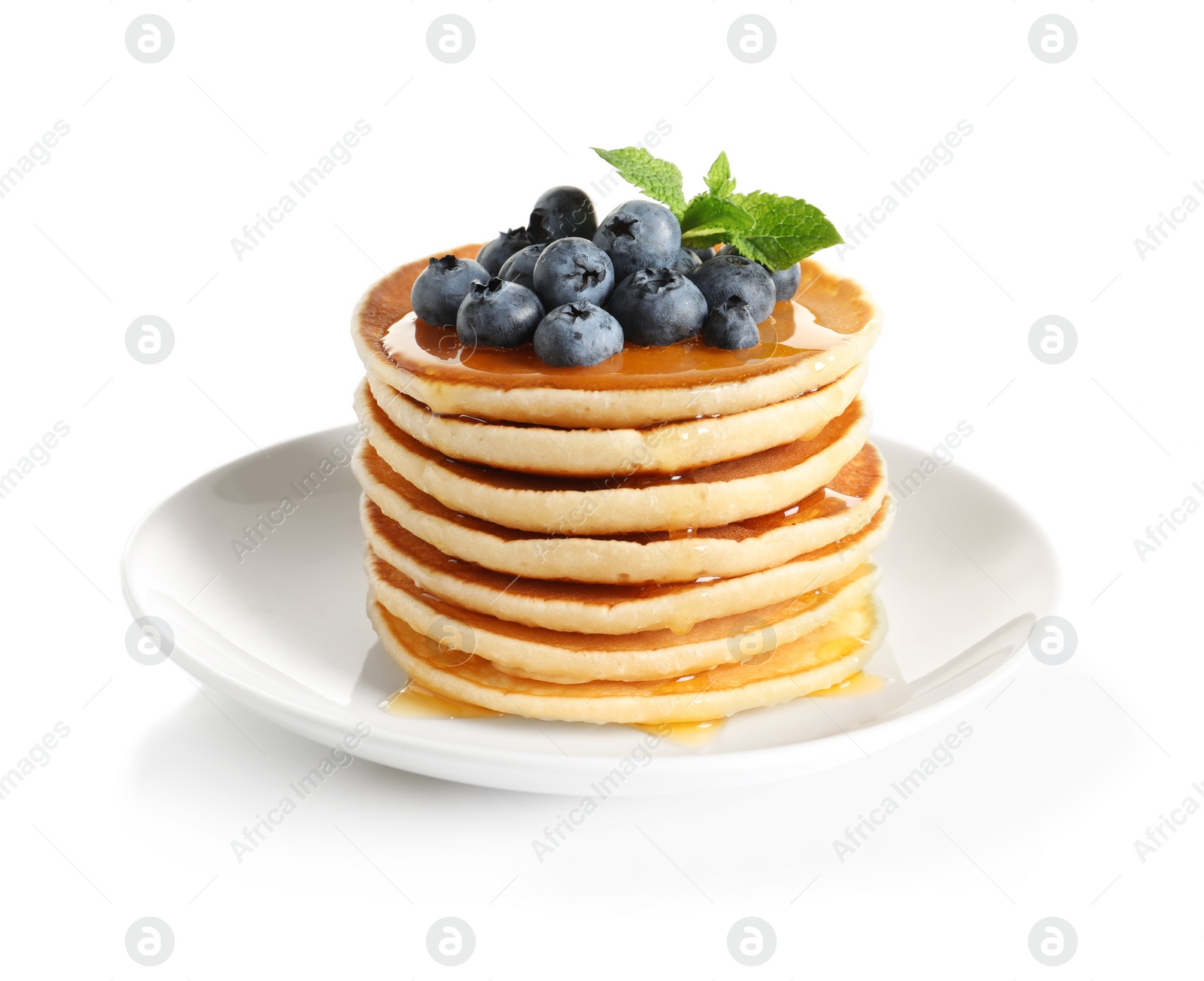 Photo of Plate with pancakes and berries on white background