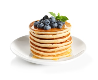 Photo of Plate with pancakes and berries on white background
