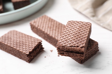 Delicious chocolate wafers on white table, closeup