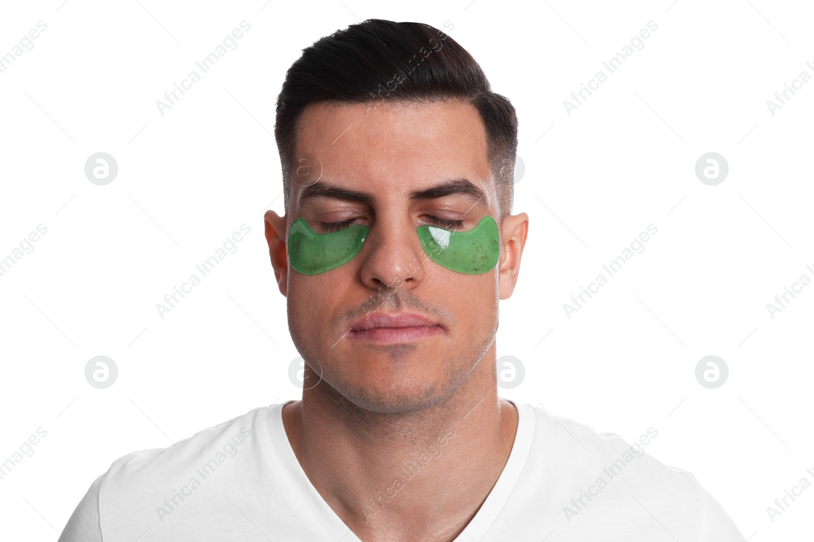 Photo of Man with green under eye patches on white background