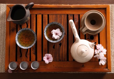 Photo of Beautiful set for traditional tea ceremony on wooden table, flat lay