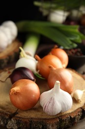Photo of Fresh onion bulbs and garlic on table, closeup