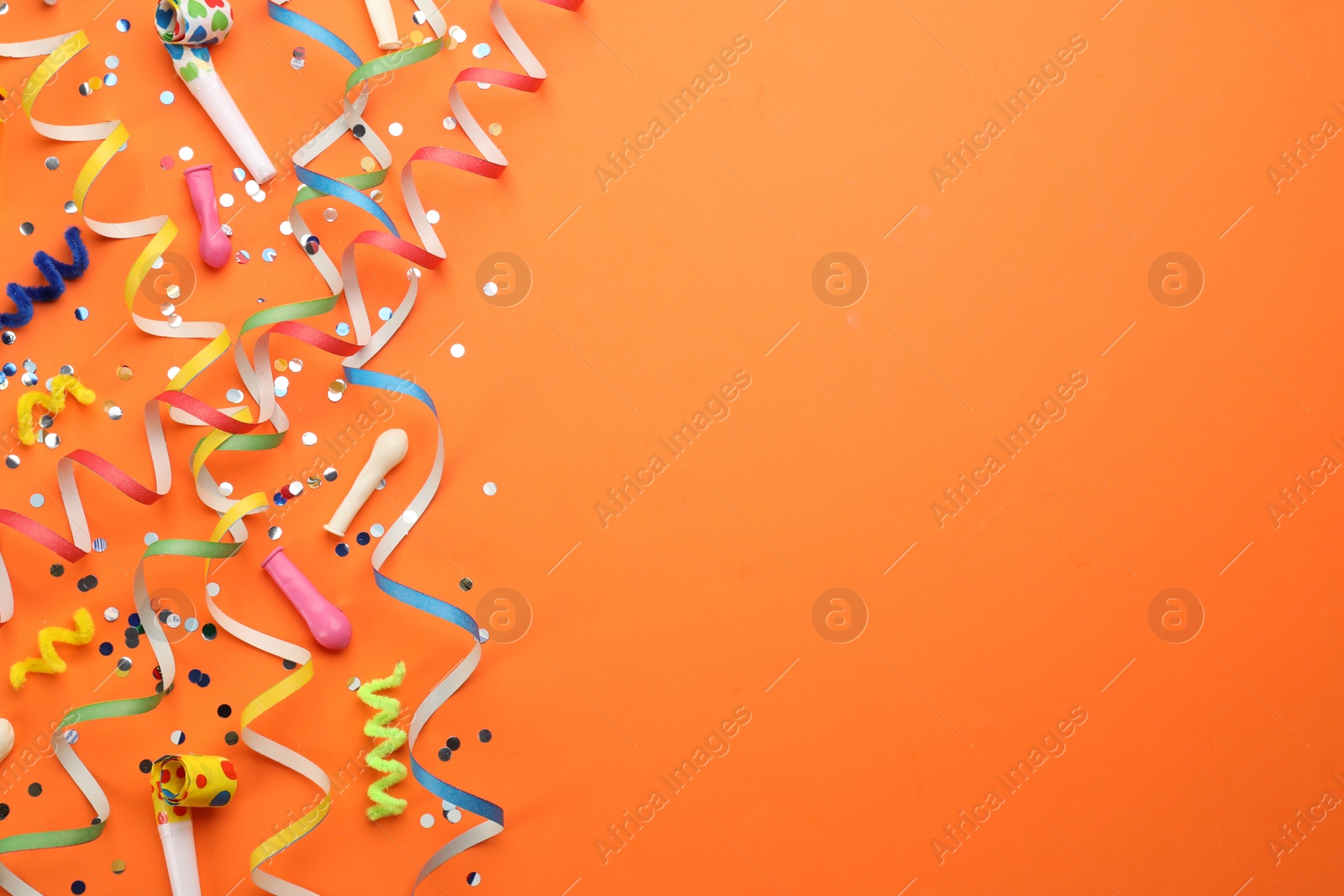 Photo of Flat lay composition with carnival items on orange background. Space for text