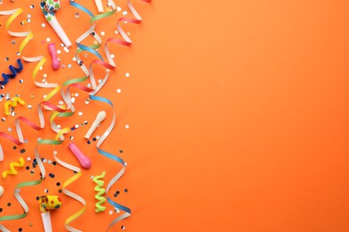 Flat lay composition with carnival items on orange background. Space for text