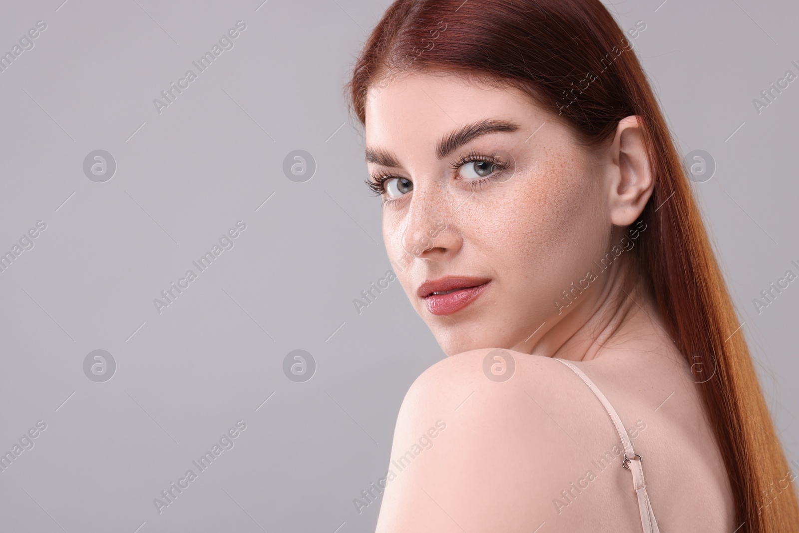Photo of Portrait of beautiful woman on grey background. Space for text