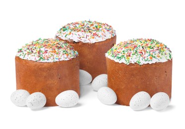Photo of Traditional Easter cakes with sprinkles and painted eggs isolated on white