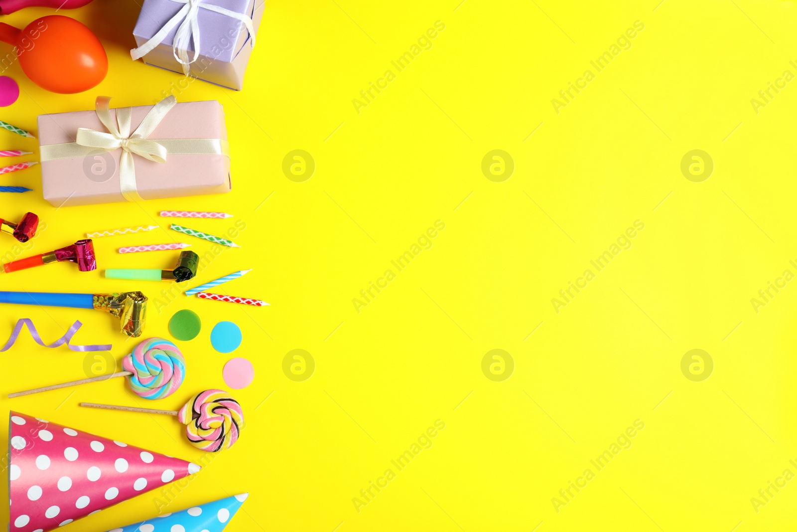 Photo of Flat lay composition with different birthday party items on yellow background, space for text