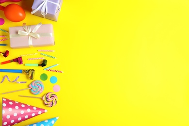 Photo of Flat lay composition with different birthday party items on yellow background, space for text