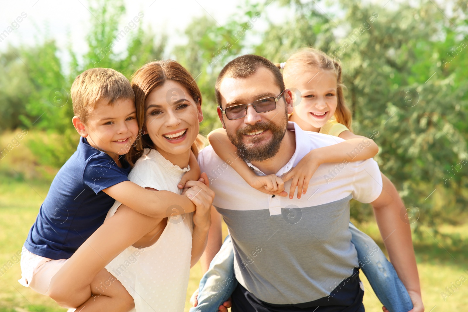 Photo of Happy family spending time together with their children outdoors