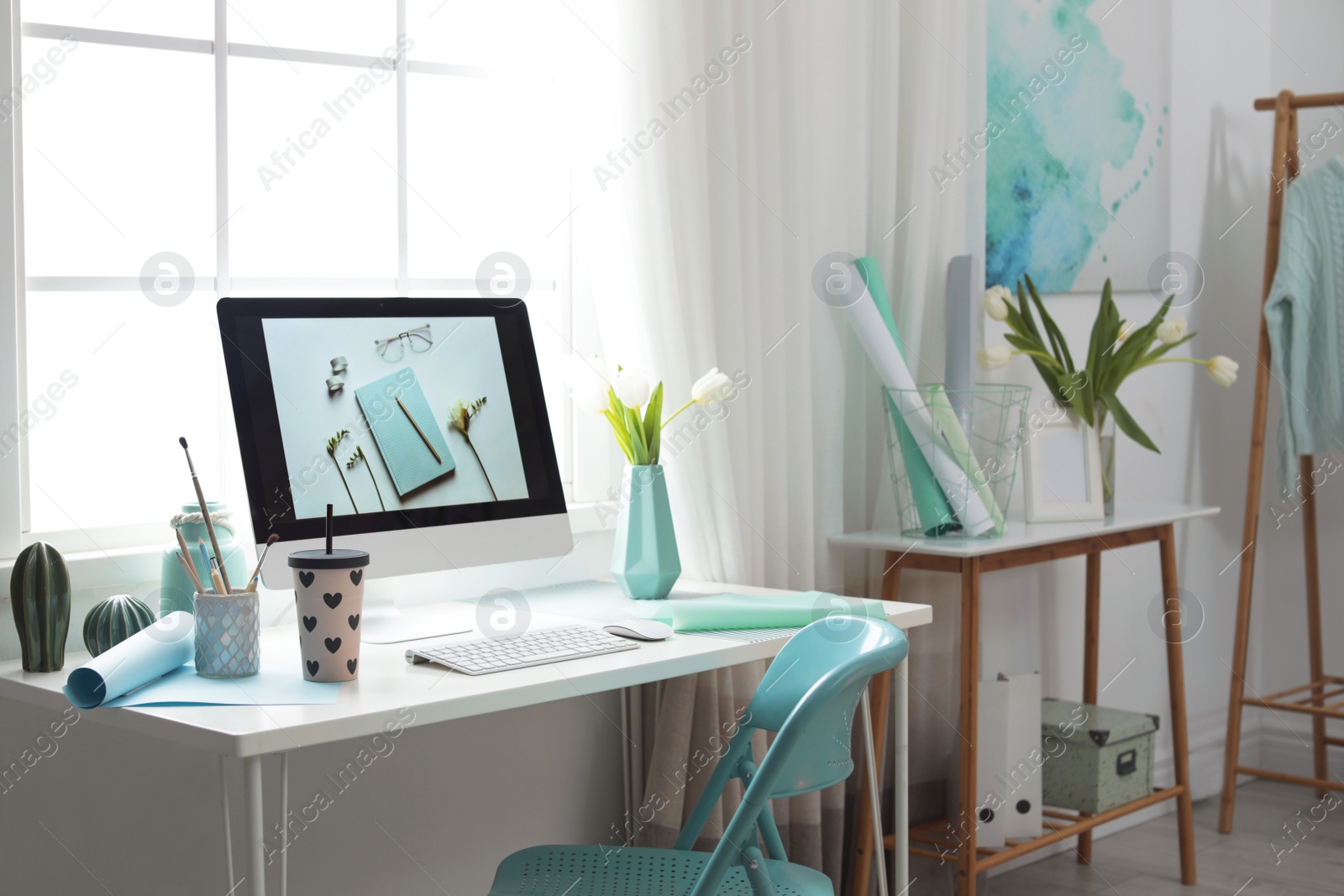 Photo of Stylish workplace interior with modern computer on desk