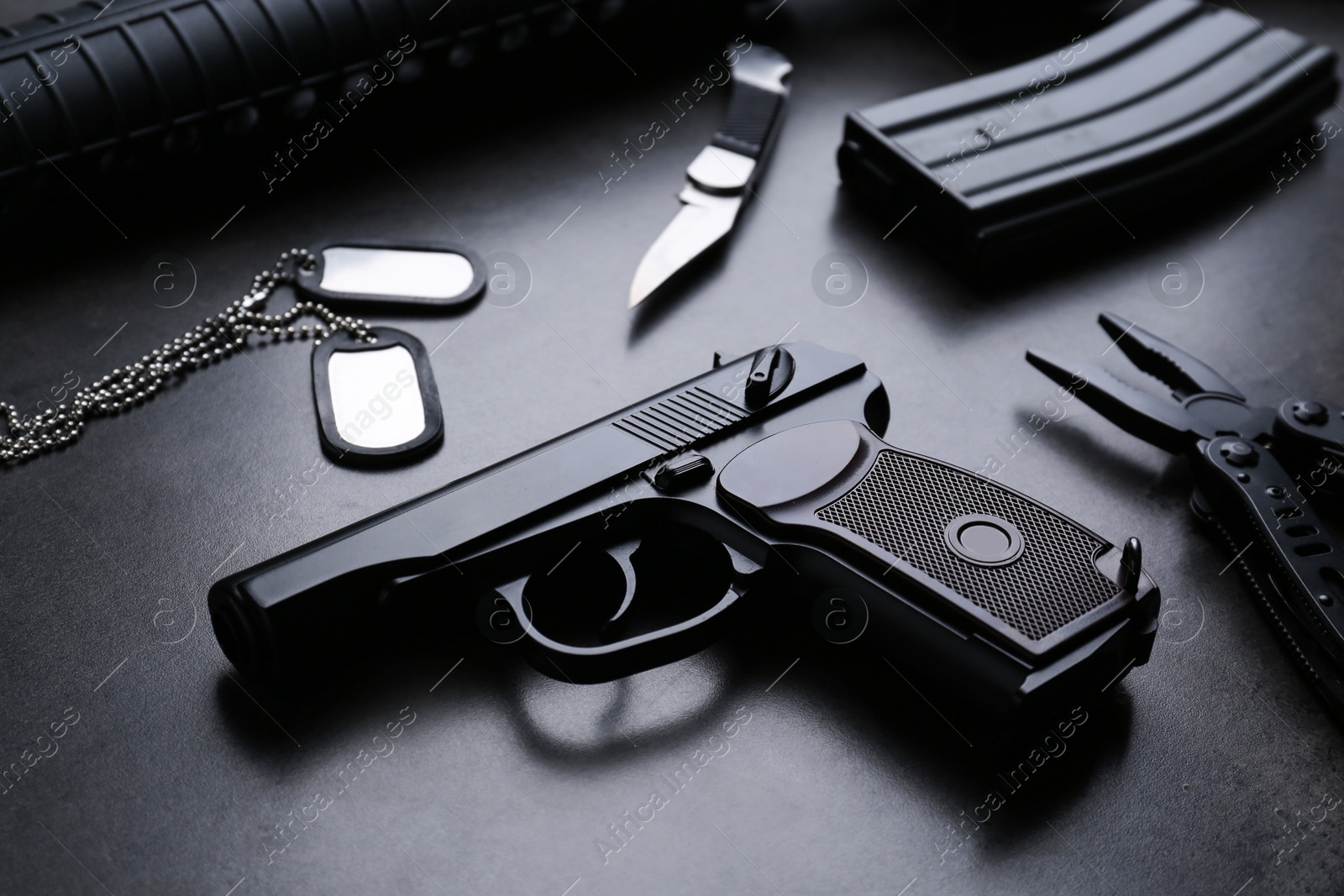 Photo of Composition with professional gun on black background