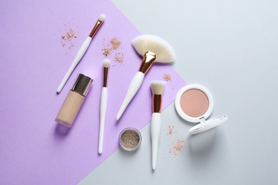 Flat lay composition with makeup brushes on color background