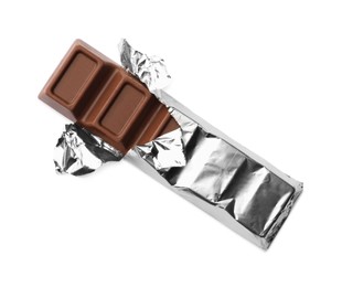 Delicious wrapped chocolate bar on white background, top view