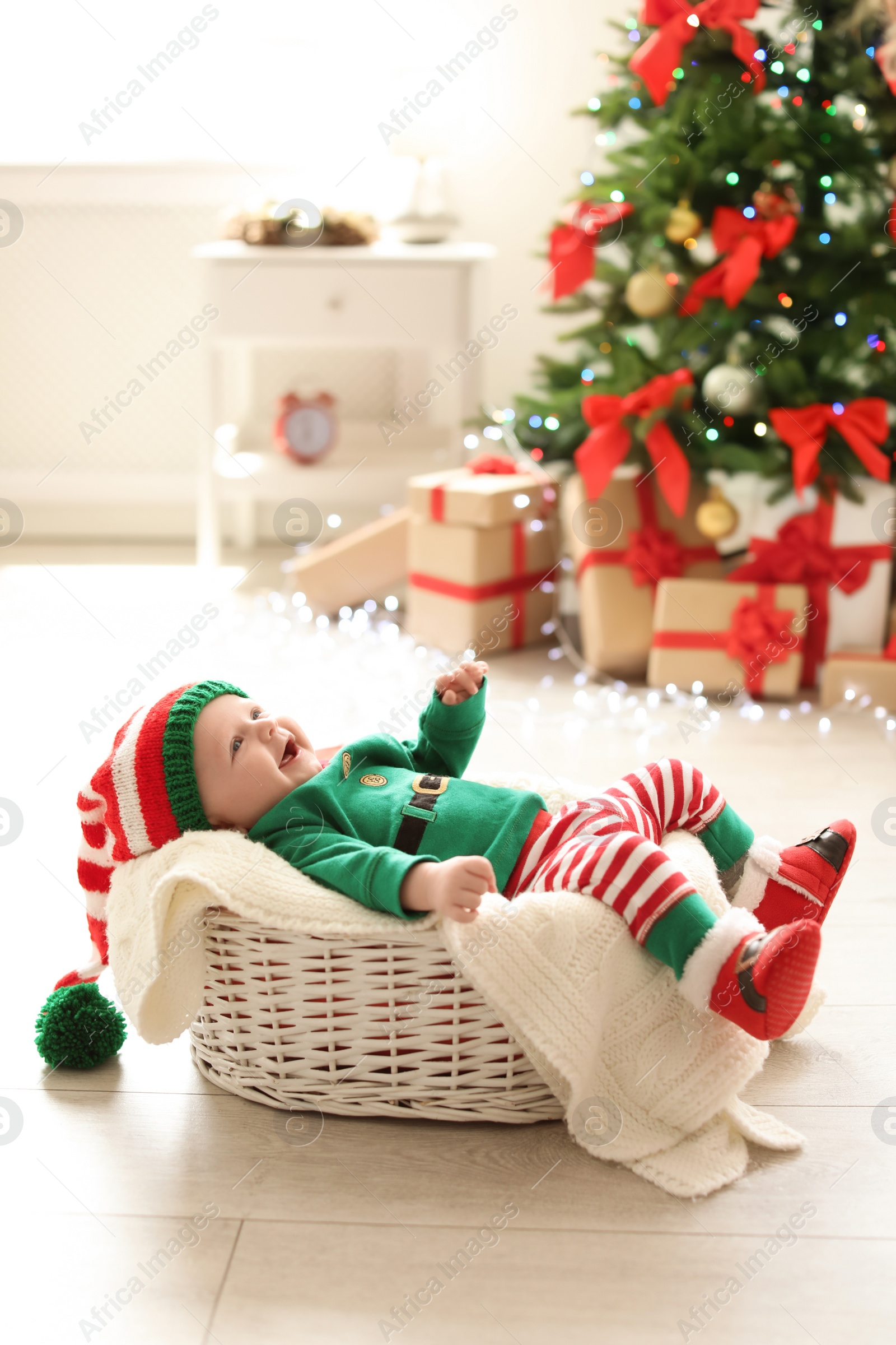 Photo of Cute baby in Christmas costume at home