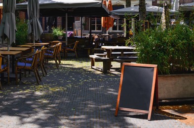 Beautiful view of outdoor cafe with stylish furniture on sunny day