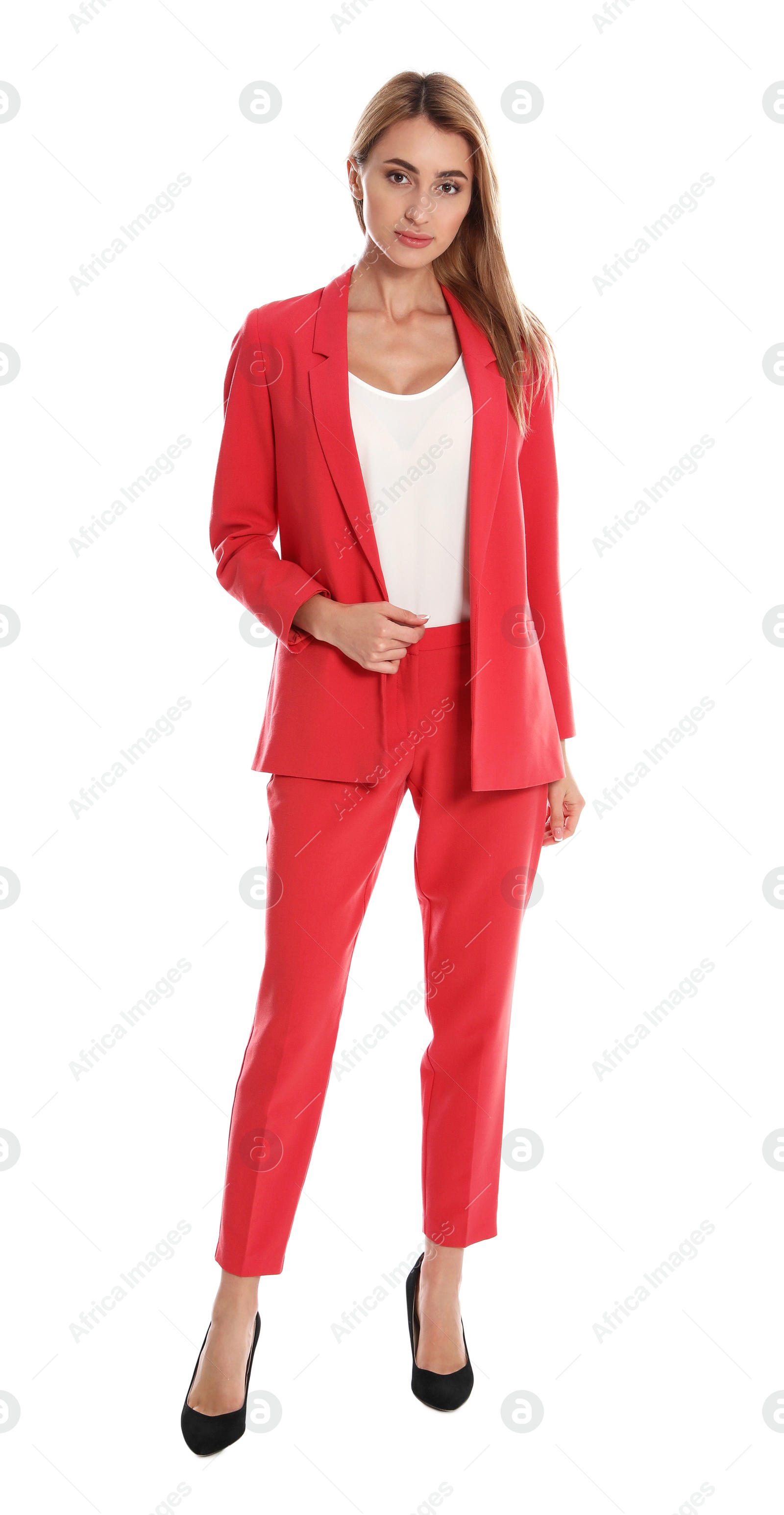 Photo of Beautiful young woman in red suit posing on white background