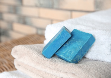 Photo of Blue handmade soap bars on clean towels. Space for text