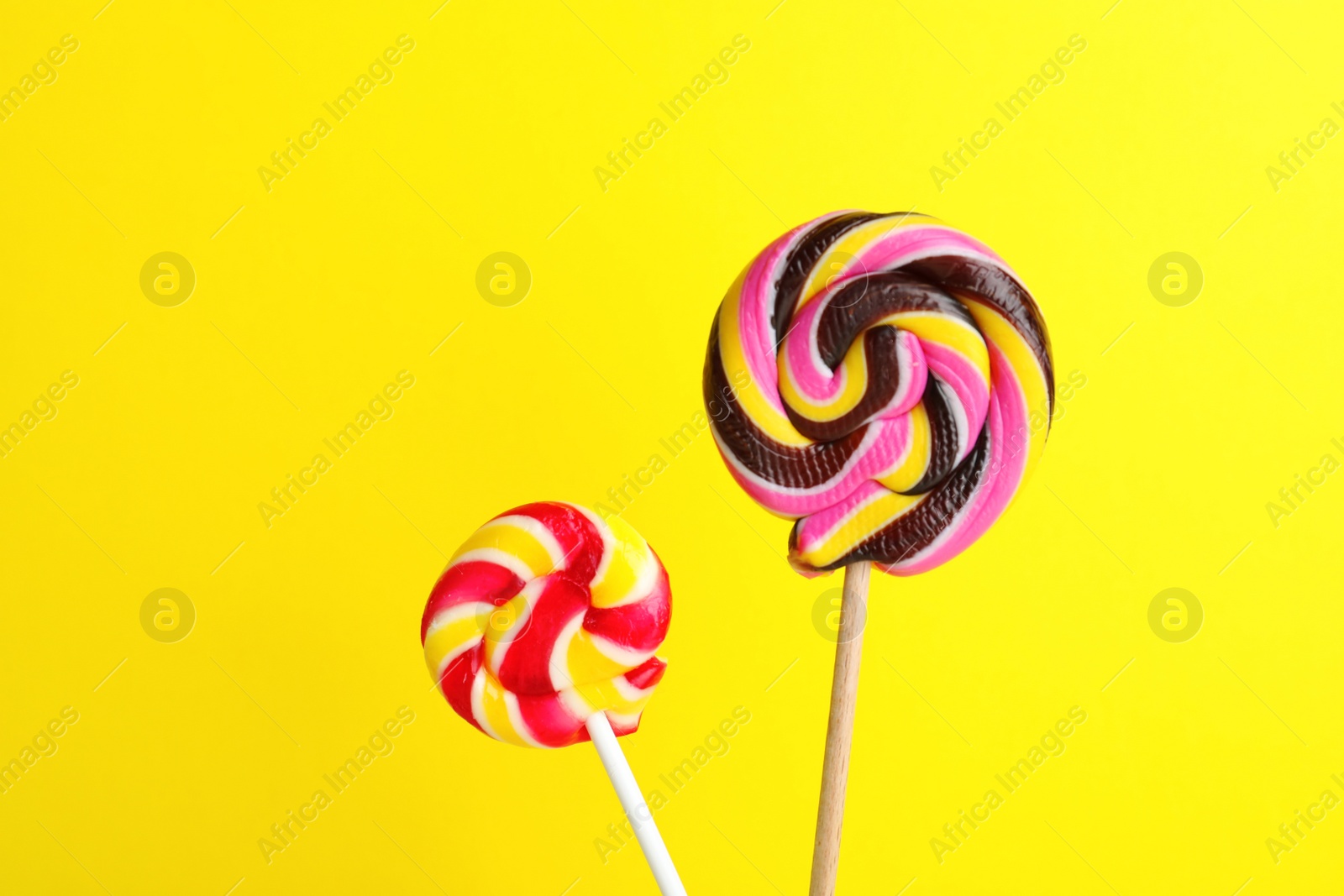 Photo of Different bright yummy candies on color background