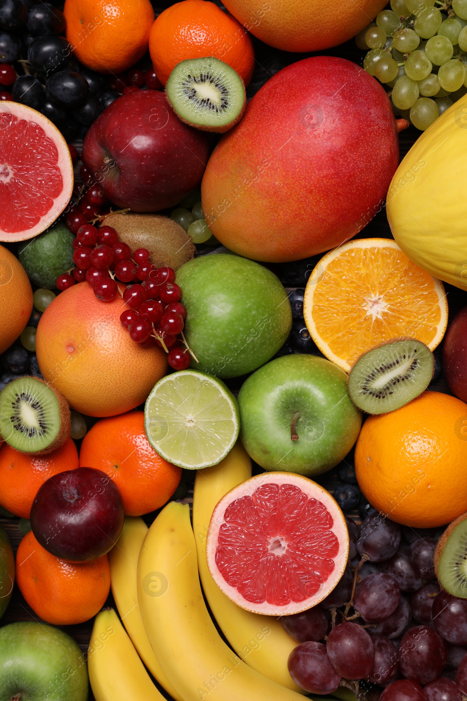 Photo of Different ripe fruits and berries as background, top view