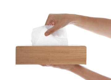 Woman taking paper tissue from holder on white background, closeup