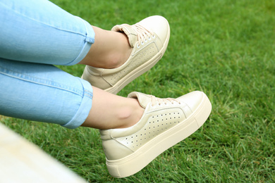 Photo of Woman wearing comfortable stylish shoes outdoors, closeup