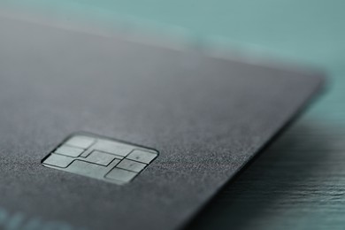 Photo of One credit card on color background, macro view