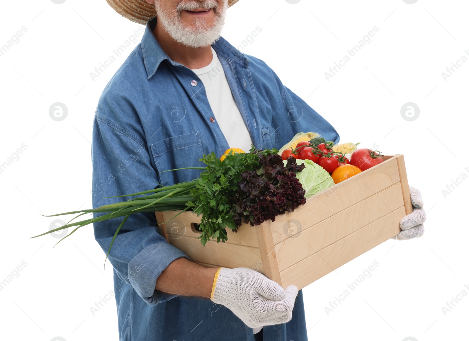 Photo of Harvesting season. Happy farmer holding wooden crate with vegetables on white background, closeup