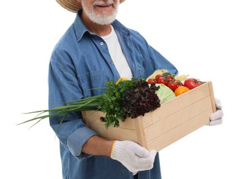 Harvesting season. Happy farmer holding wooden crate with vegetables on white background, closeup