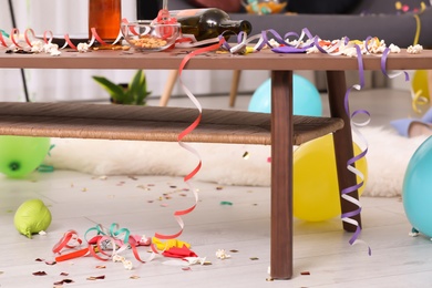 Photo of Wooden table with mess after party indoors