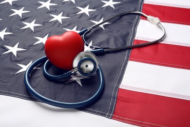 Photo of Stethoscope and red heart on American flag, closeup