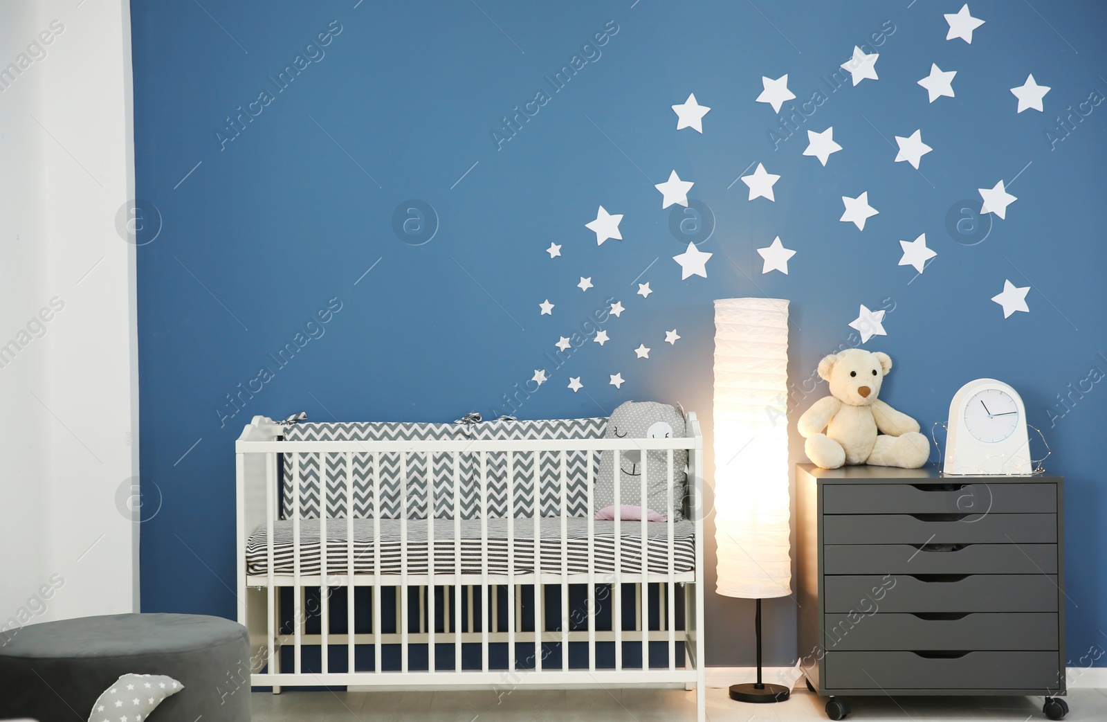 Photo of Stylish baby room interior with comfortable crib