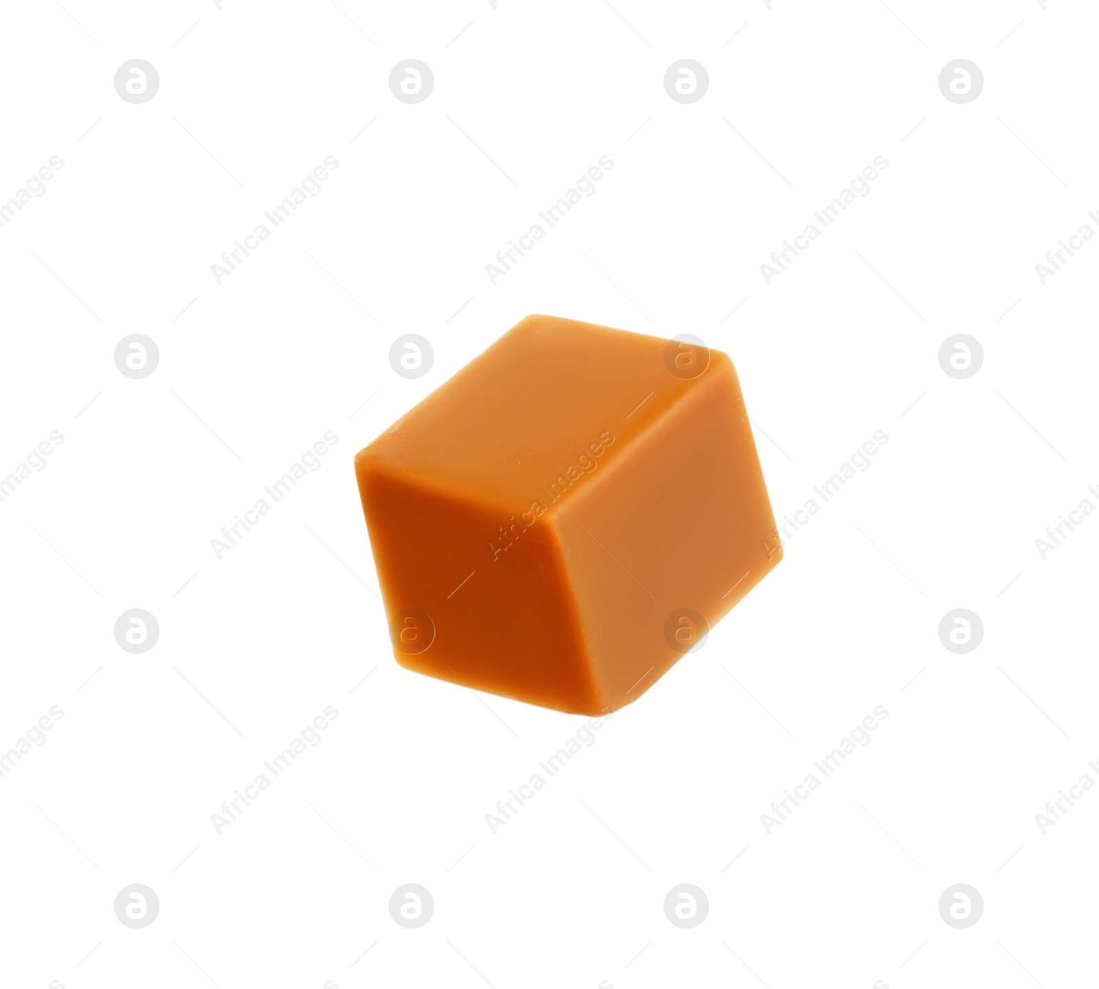 Photo of One caramel cube isolated on white. Confectionery