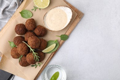 Delicious falafel balls served on light table, top view. Space for text