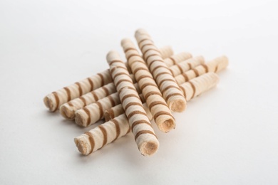 Photo of Delicious wafer rolls on white background. Sweet food