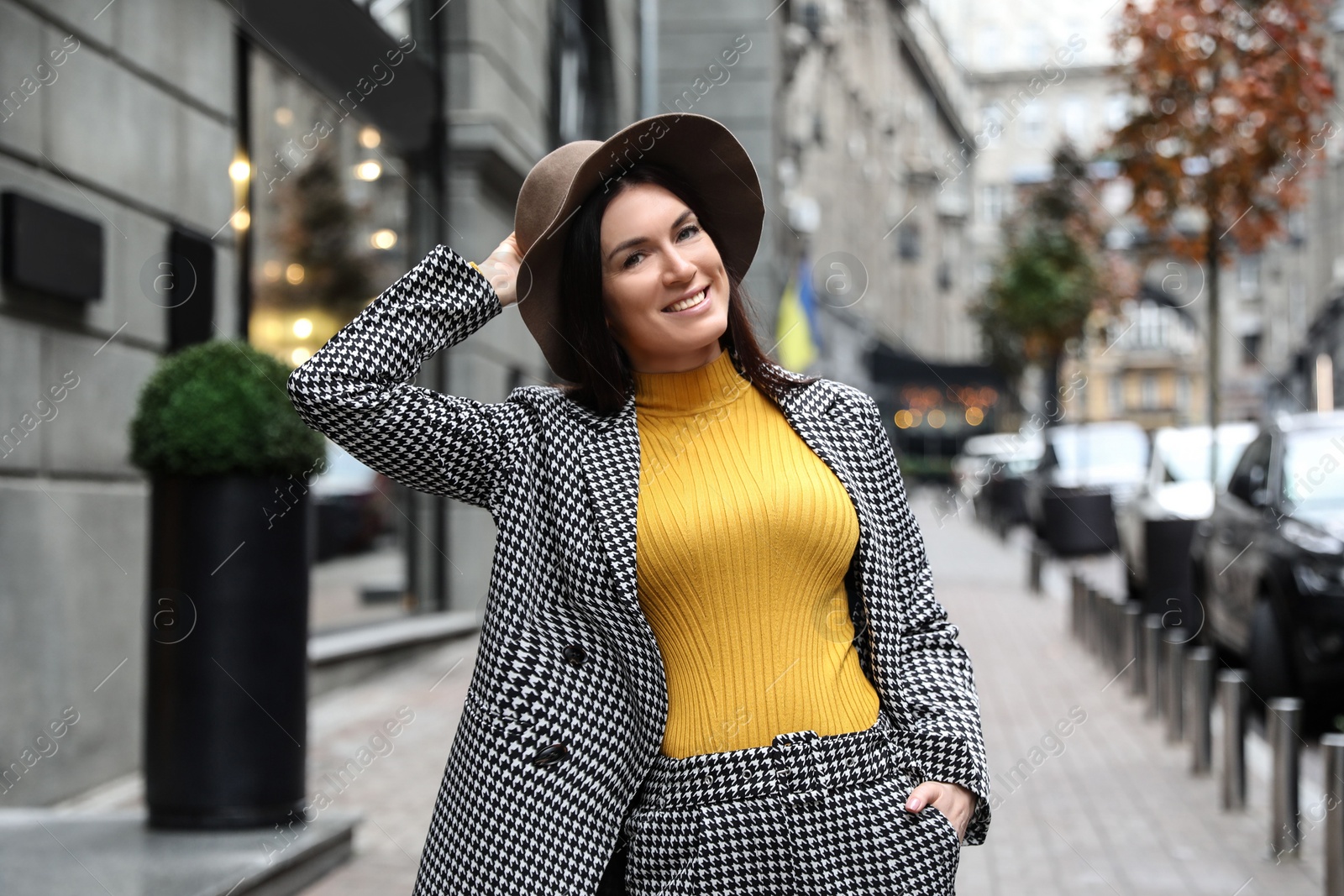 Photo of Portrait of beautiful woman in stylish suit on city street