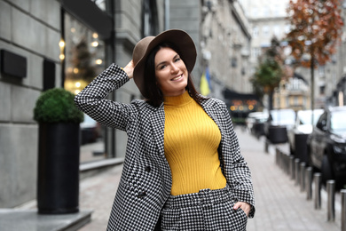 Portrait of beautiful woman in stylish suit on city street