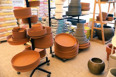 Photo of Many different flower pots in gardening shop