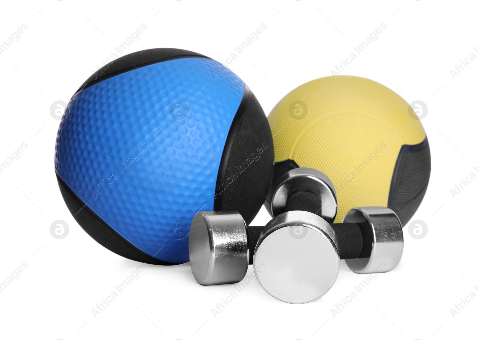 Photo of Medicine balls with dumbbells on white background