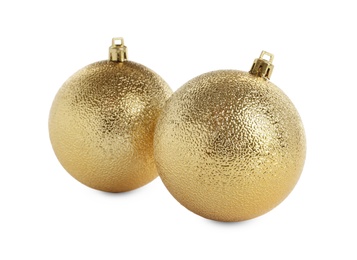 Beautiful shiny golden Christmas balls on white background