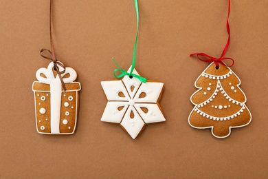 Photo of Different delicious Christmas cookies on brown background, flat lay