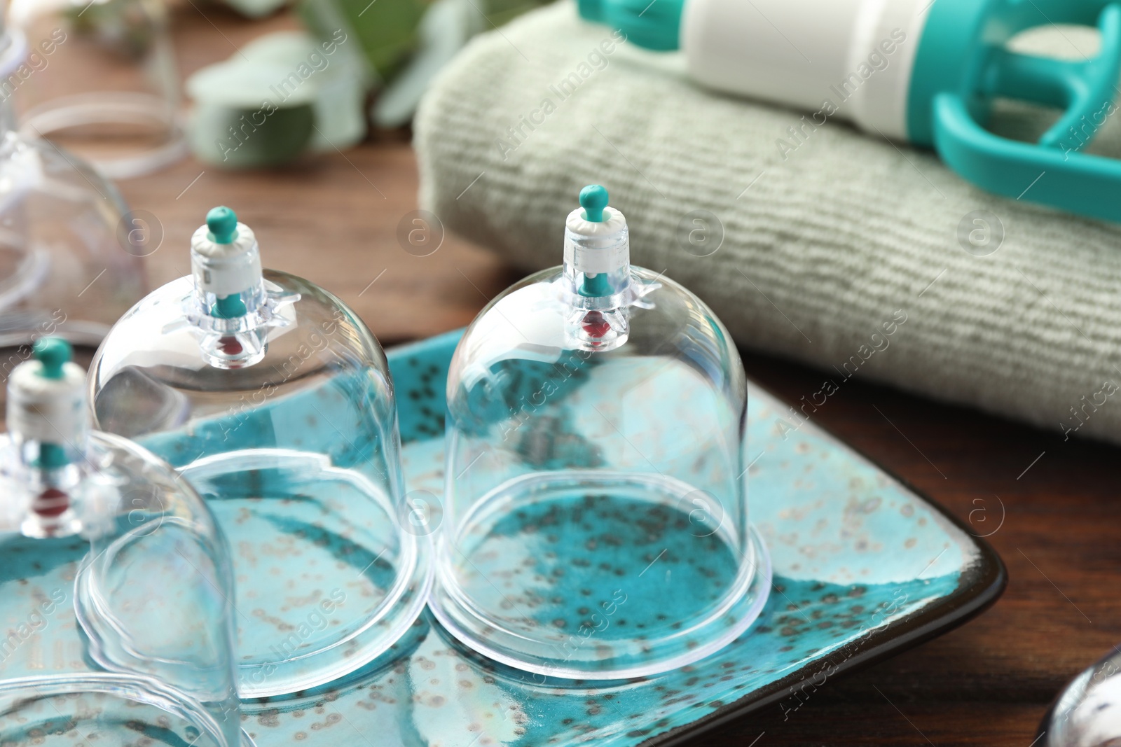 Photo of Cupping therapy. Plastic cups on table, closeup