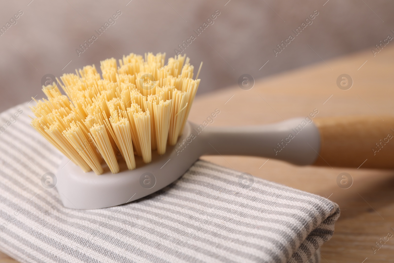 Photo of One cleaning brush and rag on table, closeup