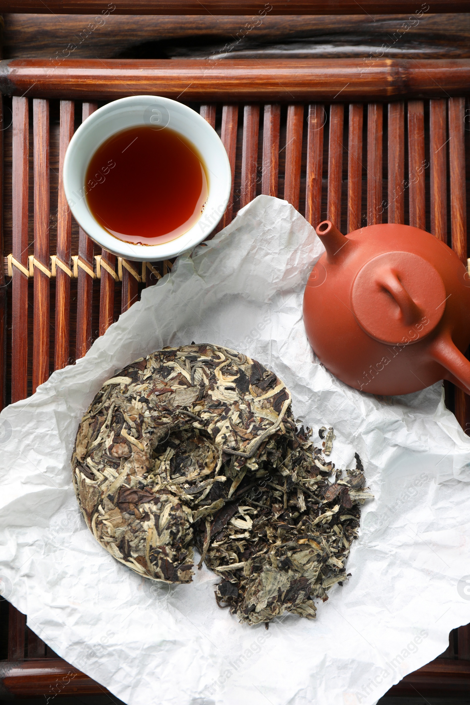 Photo of Flat lay composition with pu-erh tea on wooden tray. Traditional ceremony