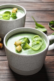 Photo of Fresh vegetable detox soup made of broccoli served on table