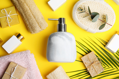 Photo of Flat lay composition with marble soap dispenser on yellow background
