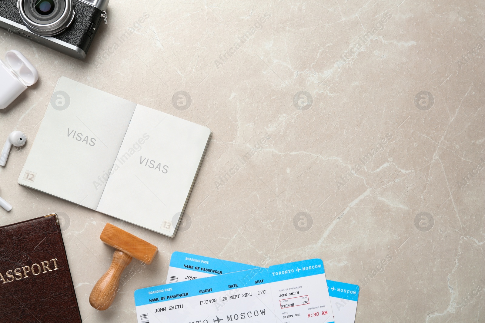 Photo of Flat lay composition with passports, stamp and flight tickets on light table, space for text