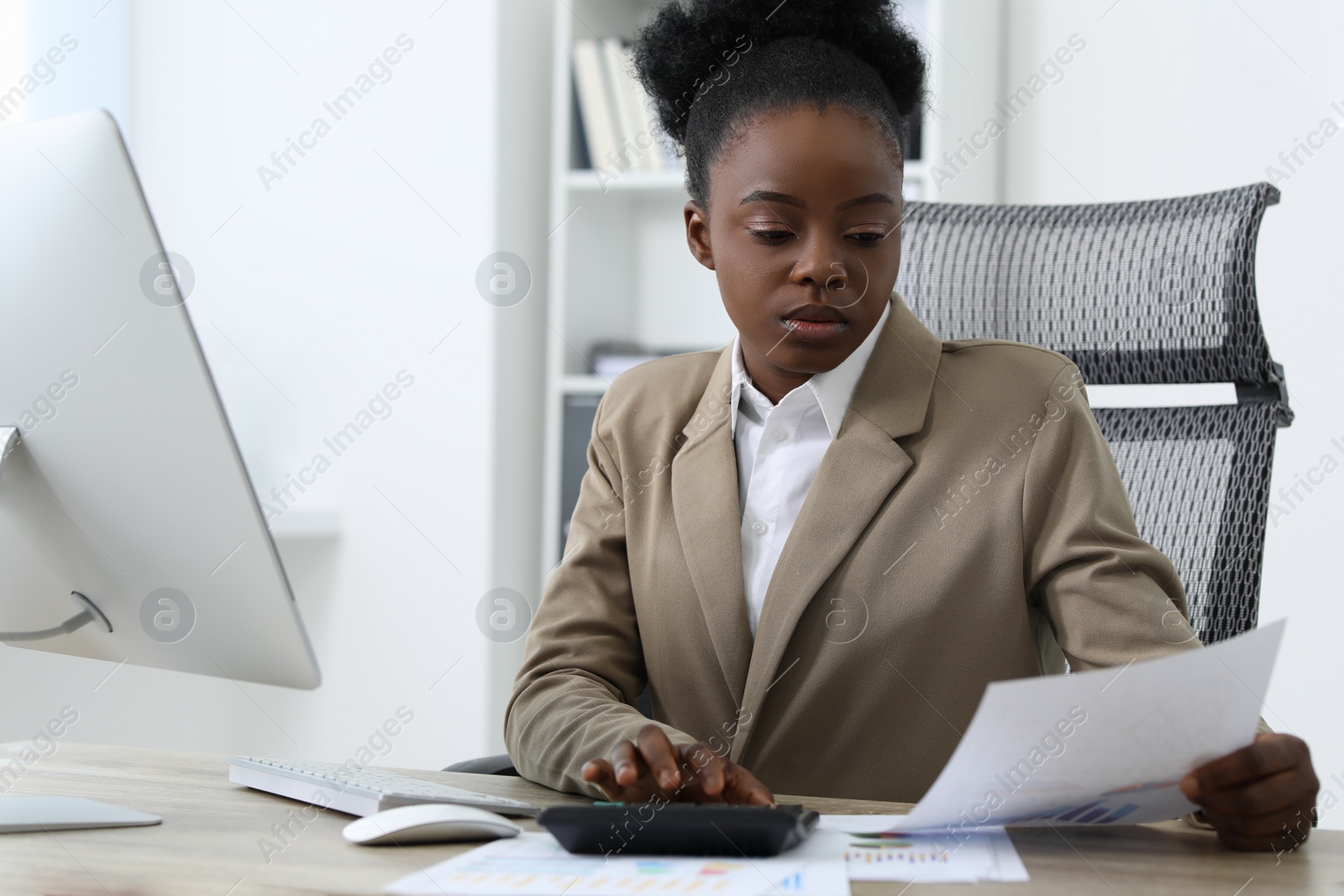 Photo of Professional accountant working at wooden desk in office