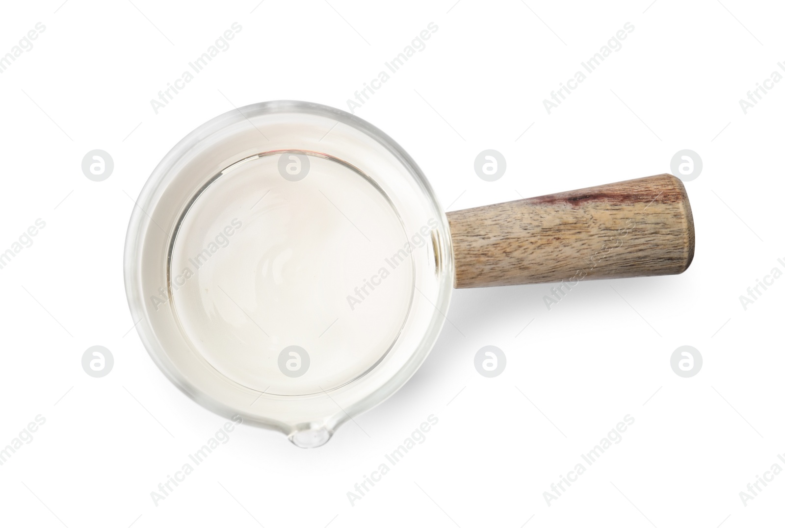 Photo of Vinegar in glass saucepan isolated on white, top view