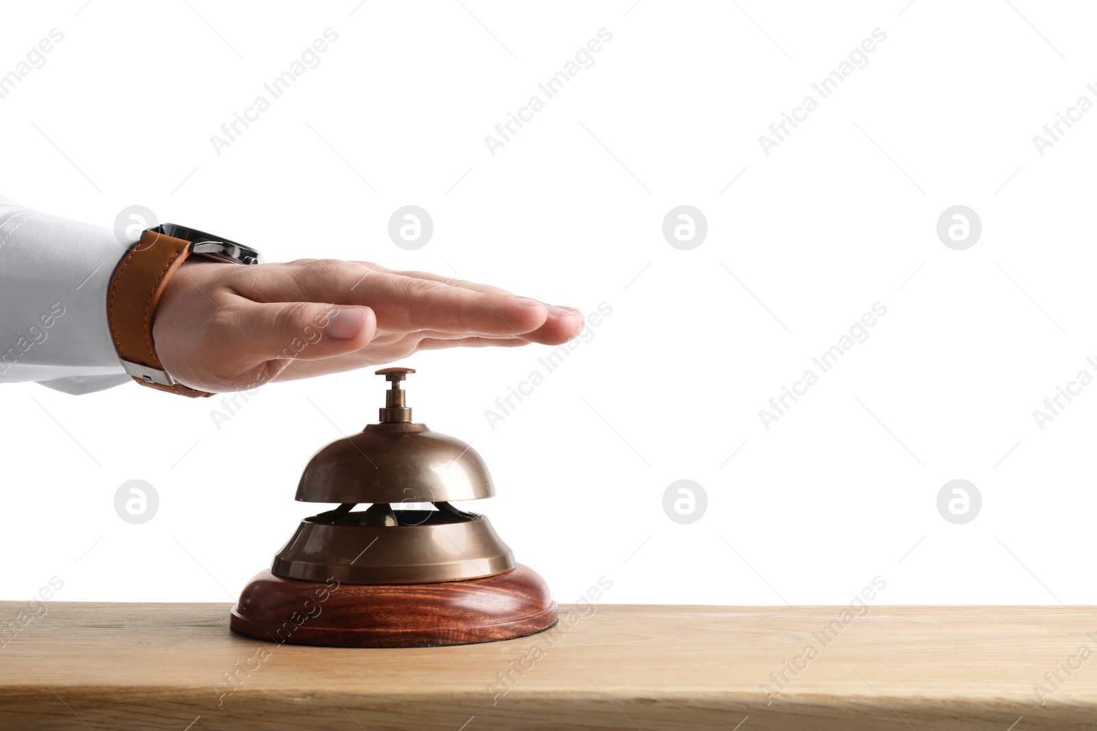 Photo of Man ringing hotel service bell at wooden table