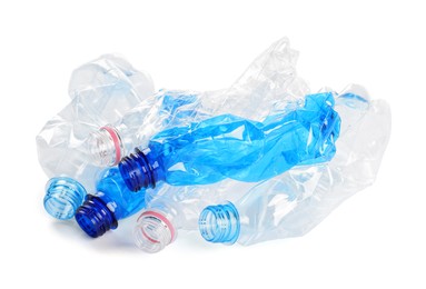 Photo of Crumpled disposable plastic bottles on white background